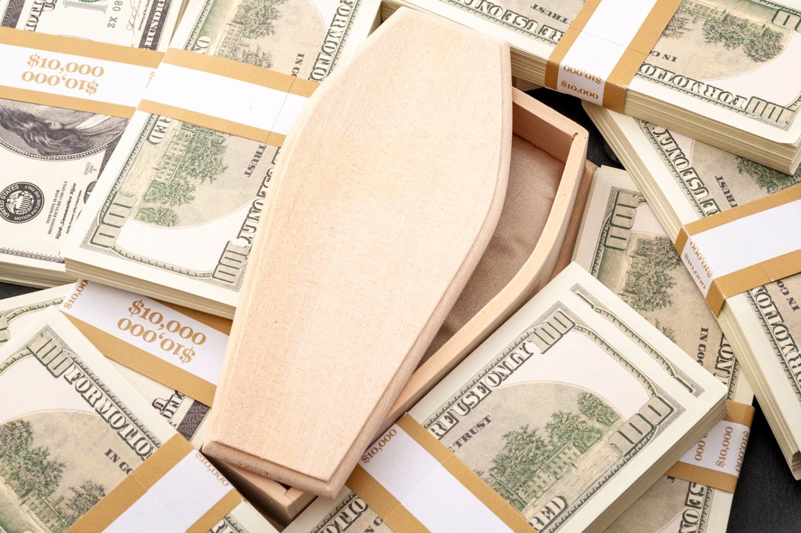 Coffin surrounded by money, representing funeral expenses