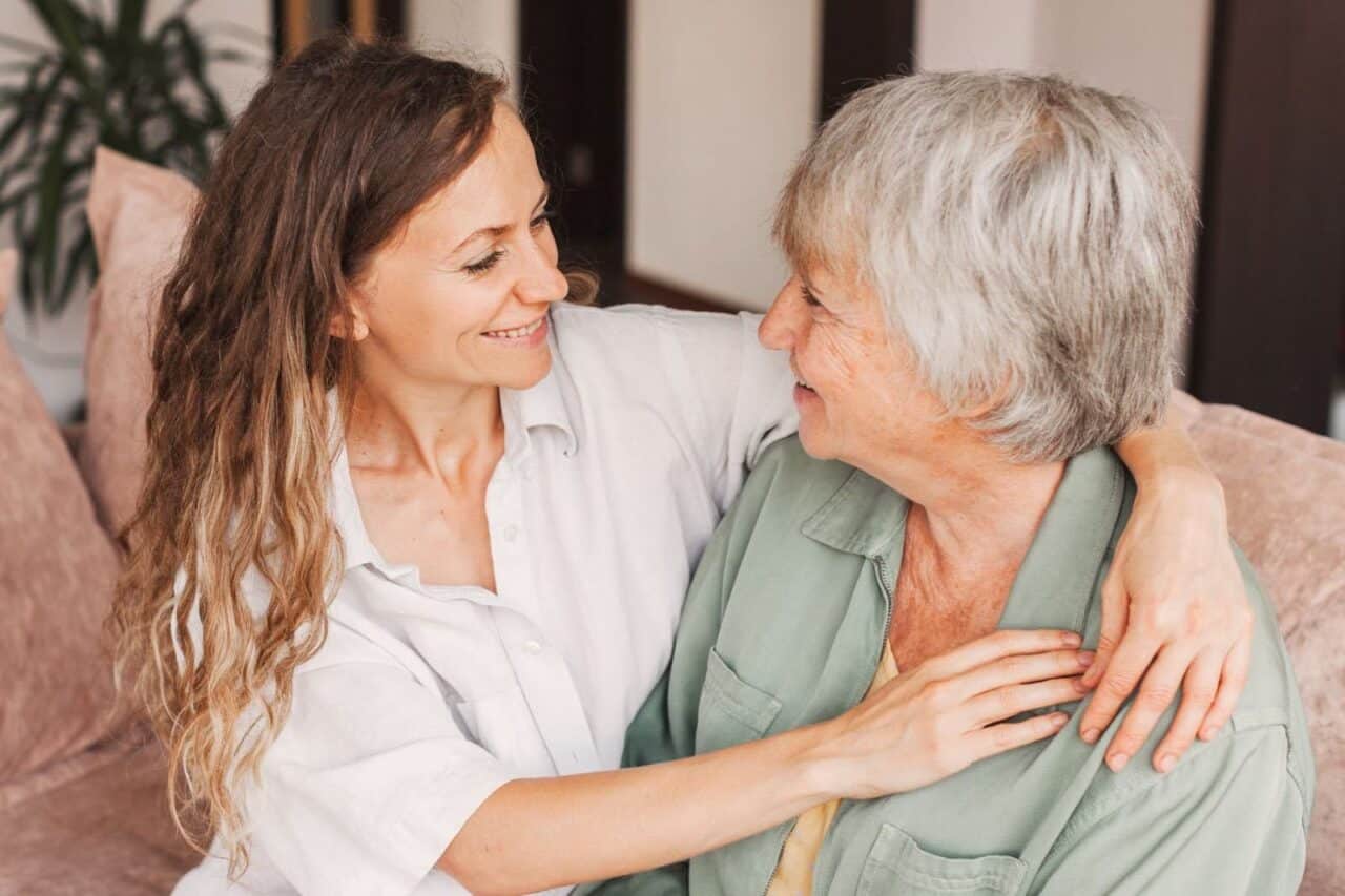 Grandmother and daughter smiling and embracing while planning for body donation