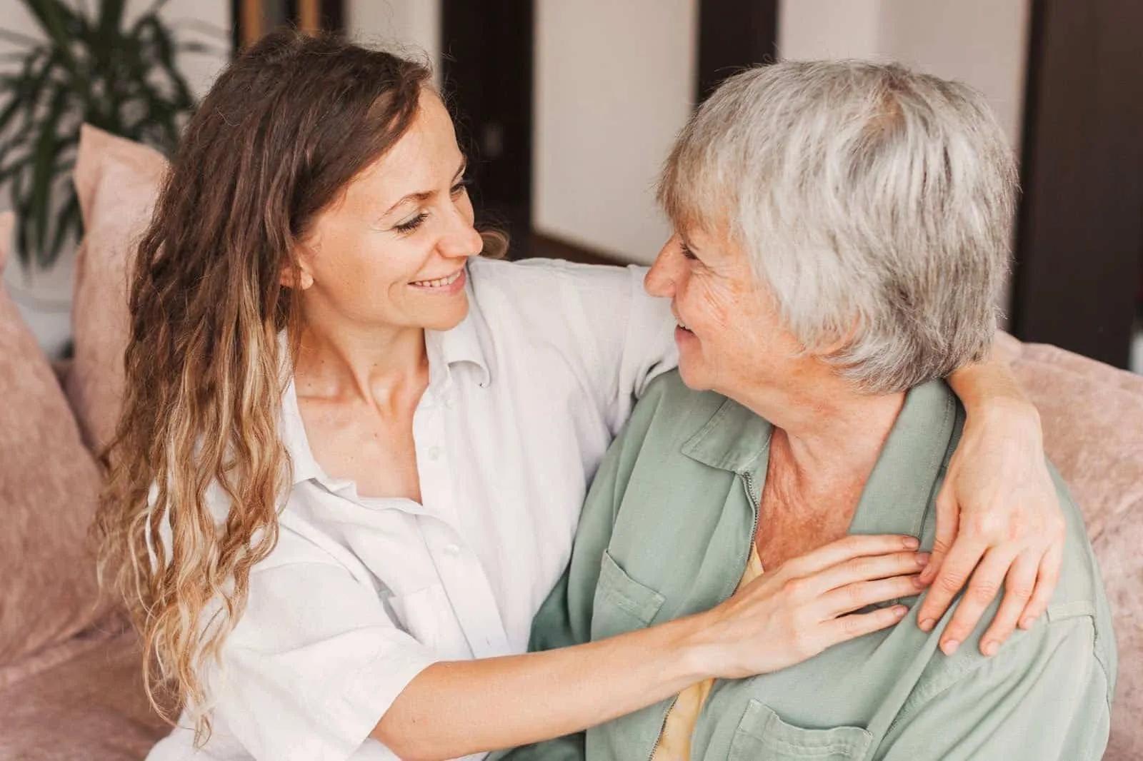 Grandmother and daughter smiling and embracing while planning for body donation