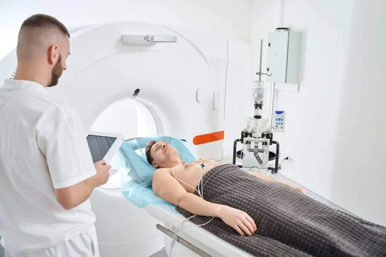 Radiographer preparing patient for stroke angiography