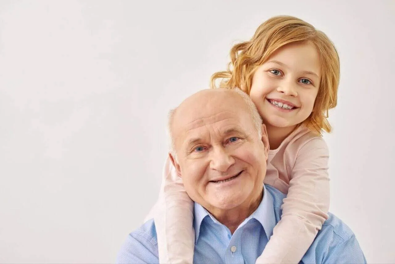 Granddaughter hugging grandfather symbolizing lasting legacy before end-of-life body donation