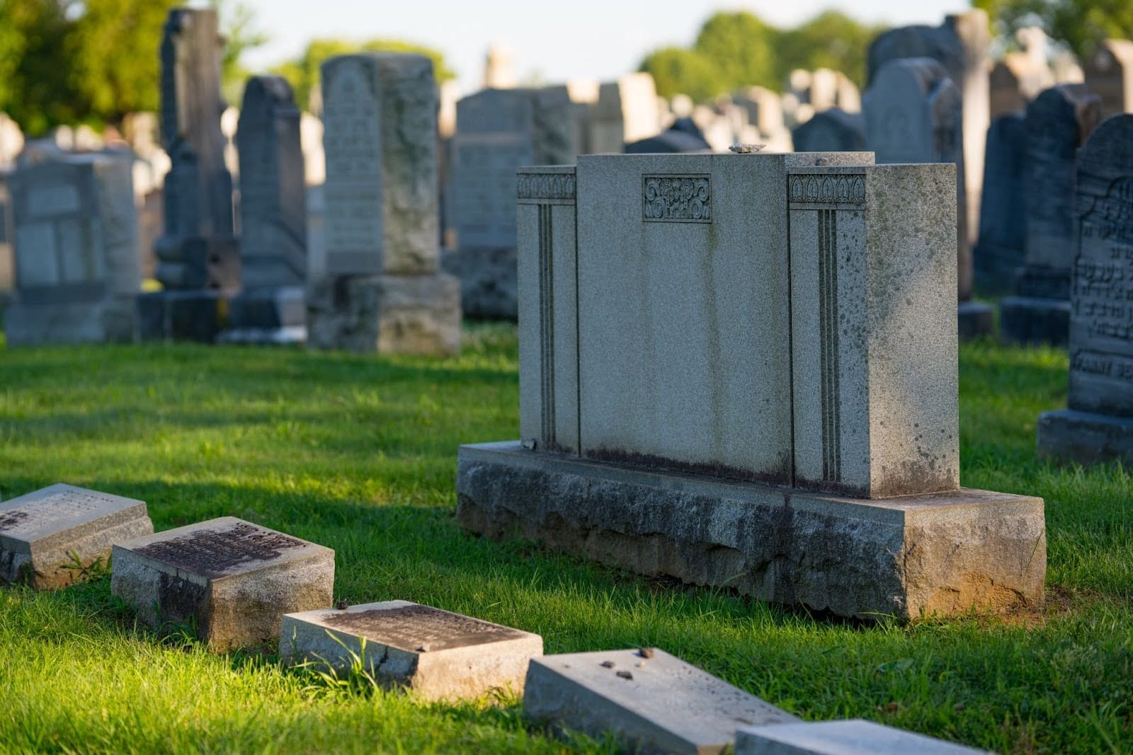 Headstones at cemetery plots in graveyard