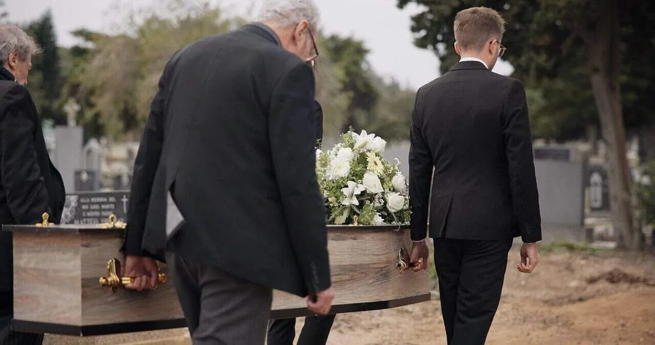 Pallbearer’s carrying casket at funeral ceremony